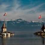 brown and white boat on water near brown wooden dock during daytime